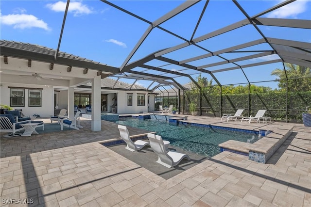 view of pool with a pool with connected hot tub, a patio, glass enclosure, an outdoor hangout area, and ceiling fan