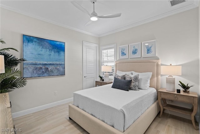 bedroom featuring visible vents, ornamental molding, wood finished floors, baseboards, and ceiling fan