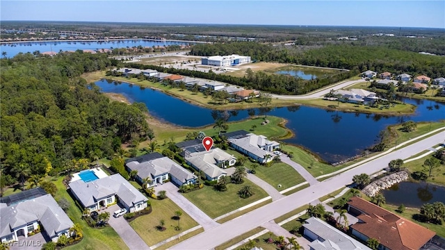 drone / aerial view featuring a residential view and a water view