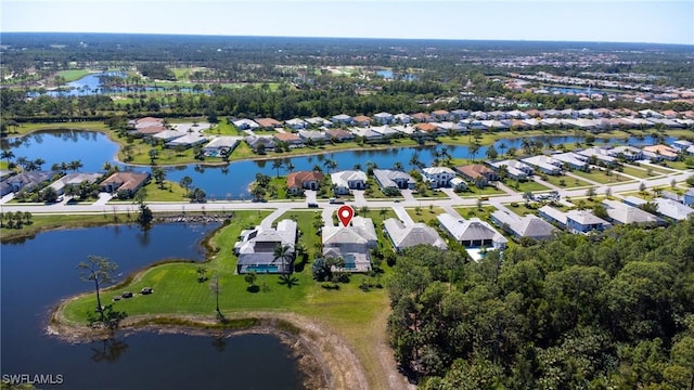 drone / aerial view featuring a residential view and a water view