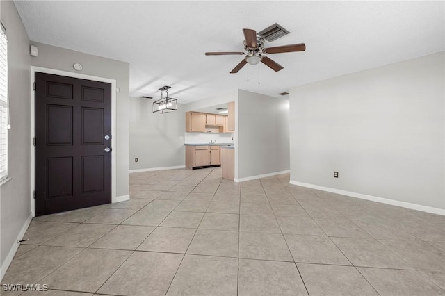 interior space featuring light tile patterned floors, visible vents, baseboards, and ceiling fan