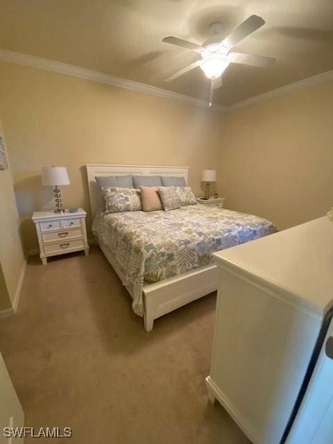 carpeted bedroom with crown molding and a ceiling fan