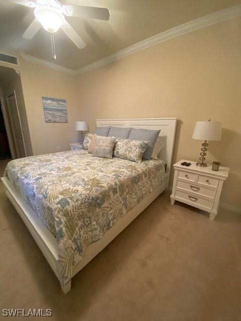 bedroom with visible vents, a ceiling fan, carpet, and ornamental molding