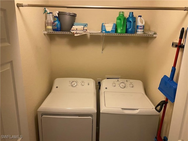 clothes washing area with laundry area and washing machine and clothes dryer