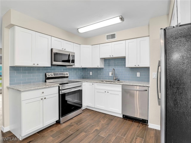 3 Knights Bridge Rd Unit A2, Naples, FL 34112 - kitchen featuring appliances with stainless steel finishes, a sink, dark wood finished floors, and tasteful backsplash