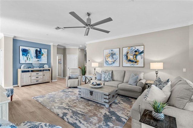 living area featuring visible vents, crown molding, baseboards, ceiling fan, and light wood-type flooring