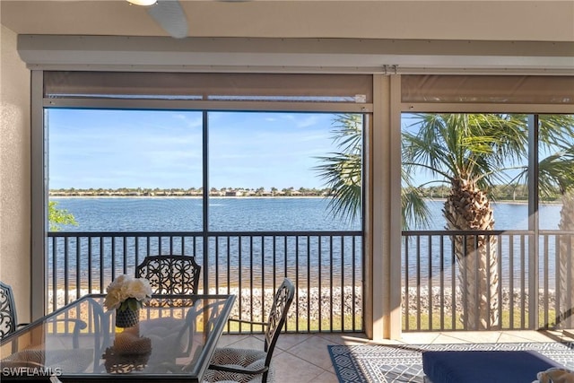 unfurnished sunroom featuring a water view