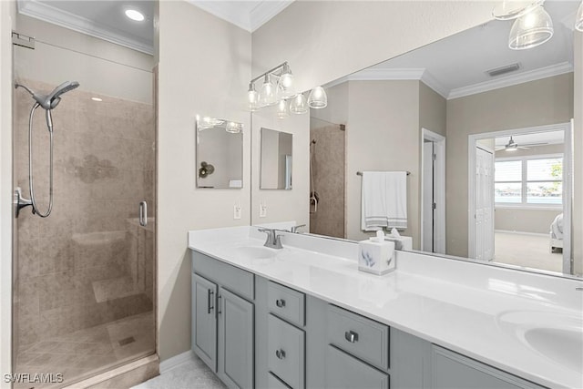 bathroom with a ceiling fan, visible vents, a stall shower, a sink, and crown molding