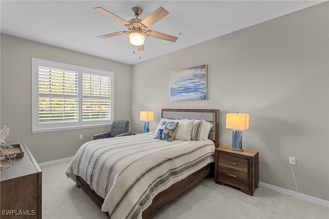 carpeted bedroom featuring baseboards and ceiling fan