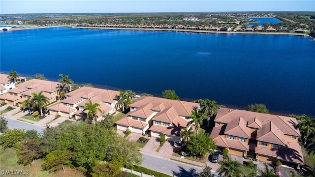 birds eye view of property with a residential view and a water view