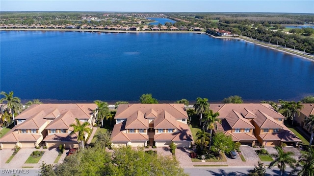 drone / aerial view with a residential view and a water view