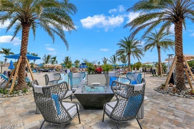 view of patio with a fire pit and playground community