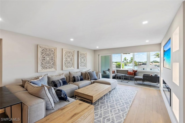 living room featuring light wood-style flooring and recessed lighting