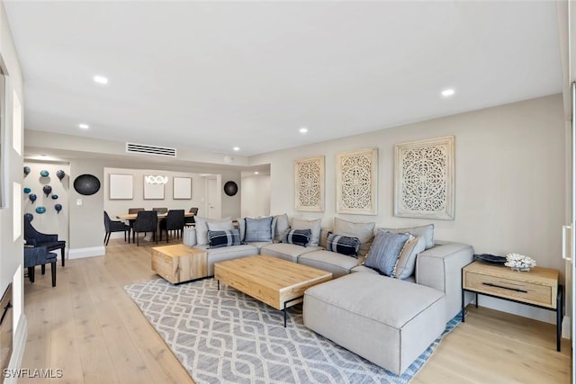 living room featuring recessed lighting, light wood-style floors, visible vents, and baseboards