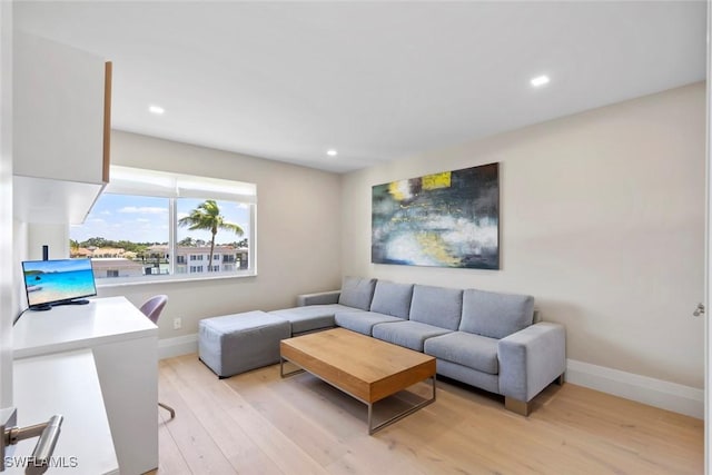 living room featuring recessed lighting, light wood-style floors, and baseboards