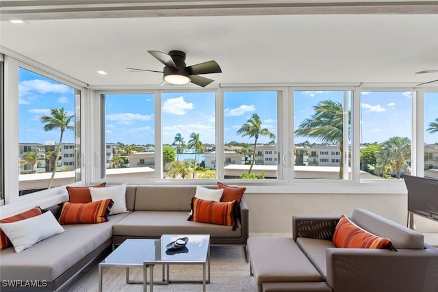 sunroom / solarium featuring ceiling fan