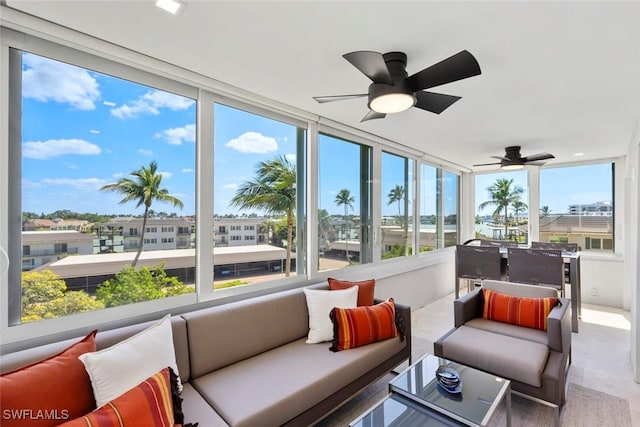 sunroom featuring a ceiling fan