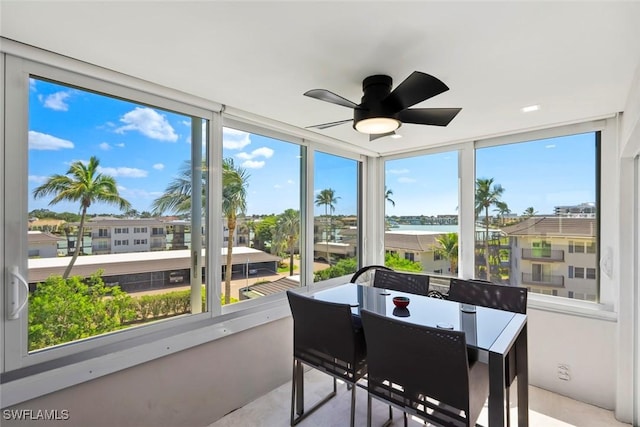 sunroom / solarium with a ceiling fan