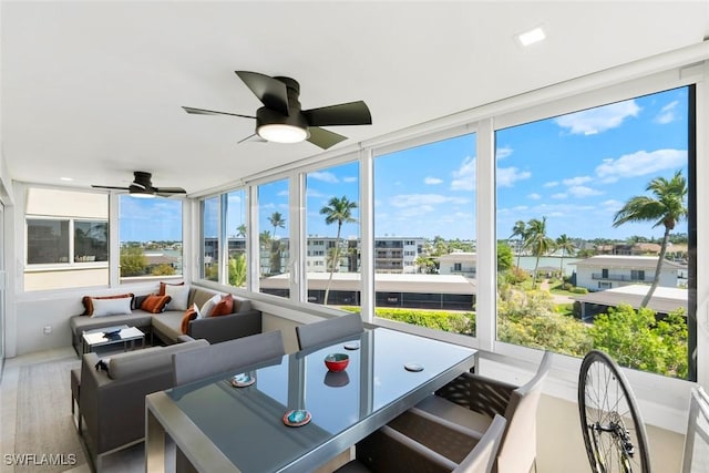 sunroom / solarium featuring ceiling fan