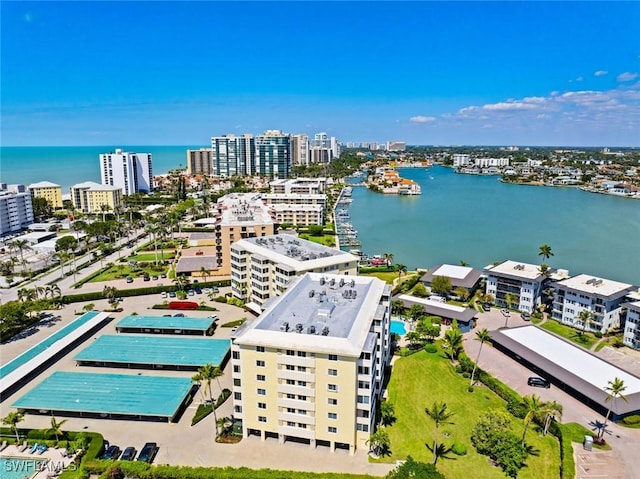 drone / aerial view featuring a city view and a water view