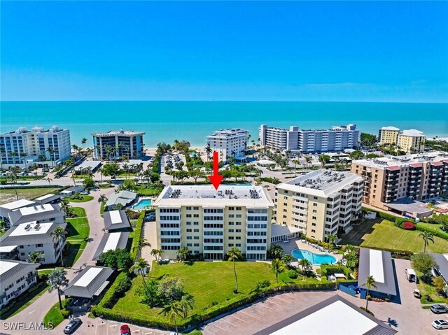 drone / aerial view featuring a water view and a city view