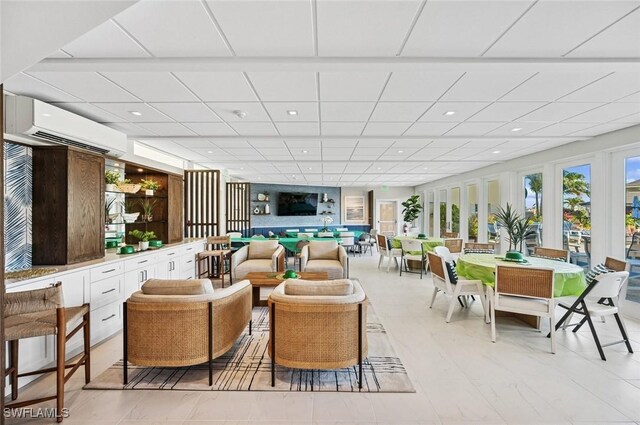 interior space with recessed lighting, a paneled ceiling, and a wall unit AC