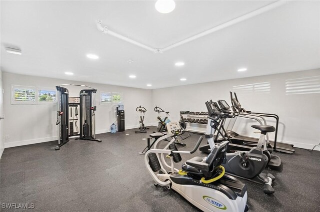 exercise room with recessed lighting and baseboards