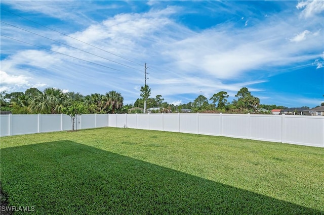 view of yard with a fenced backyard