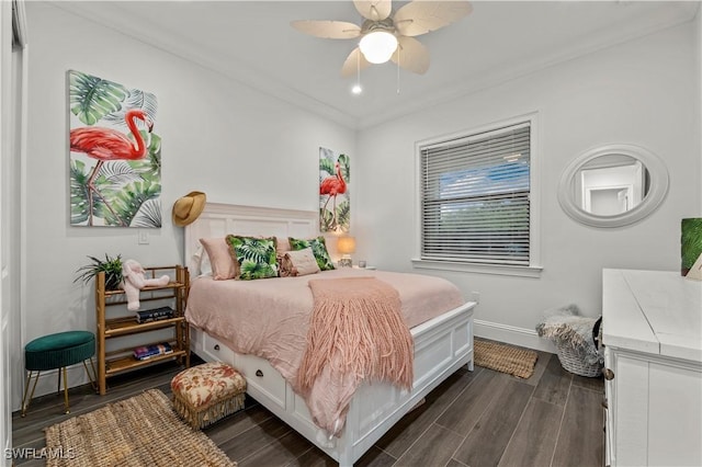 bedroom featuring ceiling fan, baseboards, dark wood finished floors, and crown molding