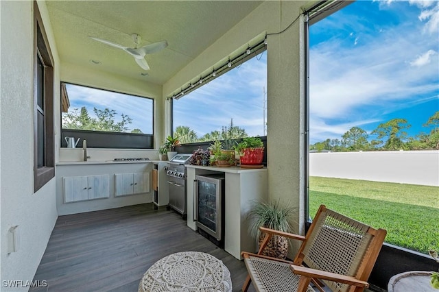 sunroom with a sink, wine cooler, and a ceiling fan