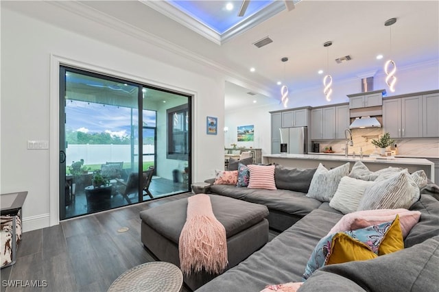 living area featuring crown molding, visible vents, and dark wood-style flooring