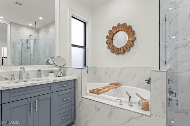 bathroom with visible vents, recessed lighting, a marble finish shower, a bath, and vanity