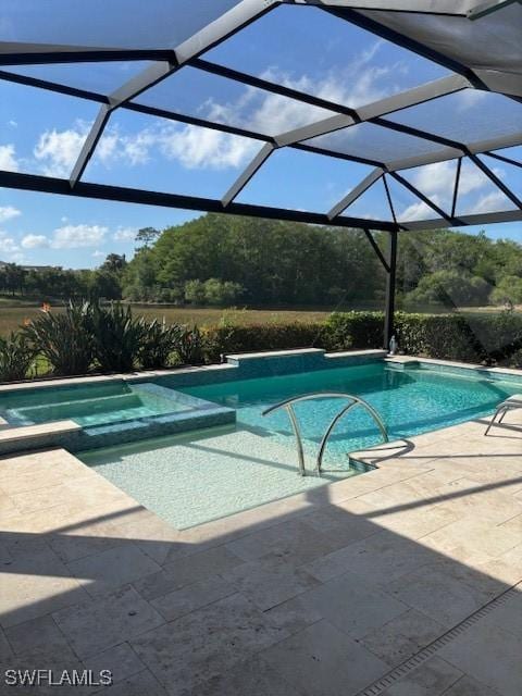 view of pool featuring a patio area and a pool with connected hot tub