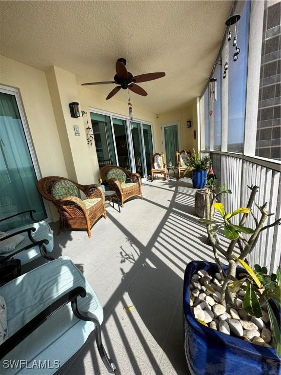 sunroom featuring ceiling fan