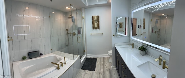 bathroom featuring a marble finish shower, a whirlpool tub, and a sink