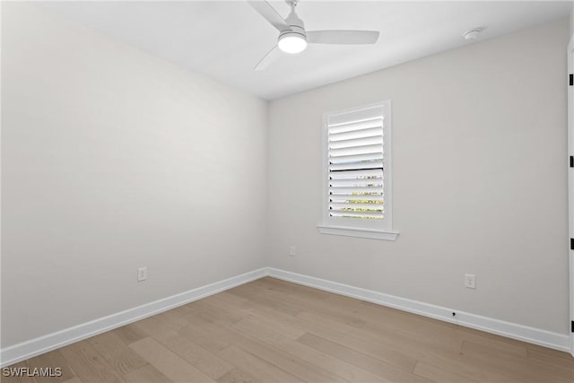 empty room featuring baseboards, light wood-style floors, and a ceiling fan