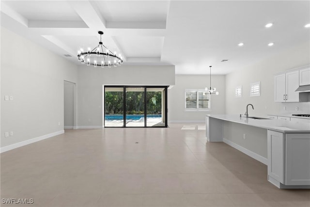 kitchen featuring a sink, open floor plan, a wealth of natural light, and a chandelier