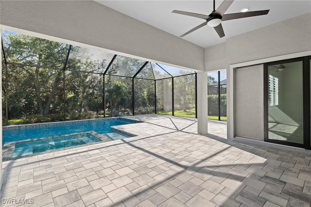 view of pool featuring a lanai, a pool with connected hot tub, a ceiling fan, and a patio