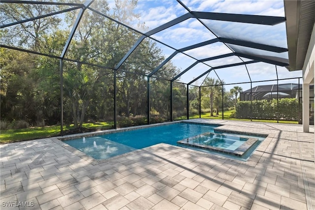 view of swimming pool with glass enclosure, a patio, and a pool with connected hot tub