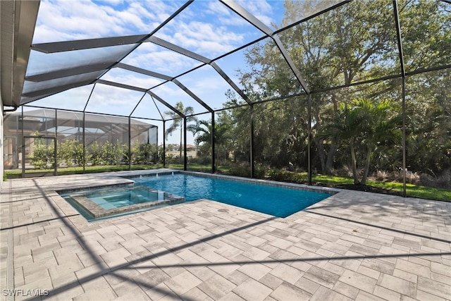 view of pool with glass enclosure, a patio area, and a pool with connected hot tub