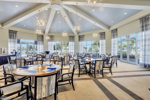 dining area featuring a chandelier, beam ceiling, light colored carpet, and high vaulted ceiling