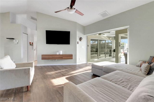 living area featuring vaulted ceiling, a ceiling fan, visible vents, and wood-type flooring