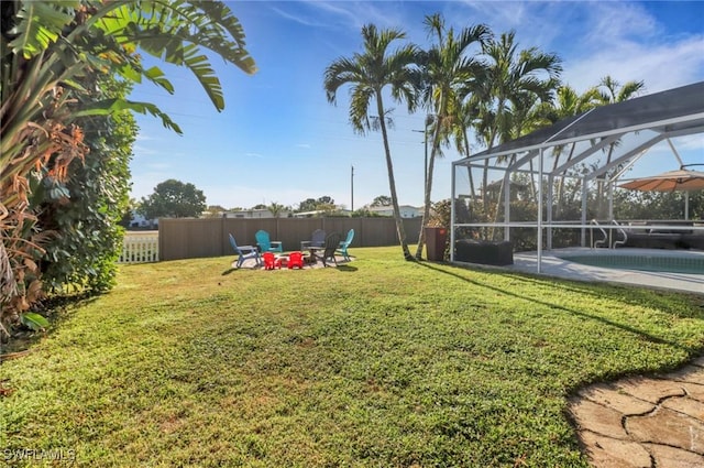 view of yard with glass enclosure, a patio, a fenced in pool, and fence