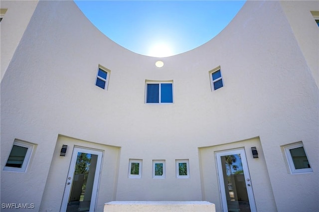 rear view of house with stucco siding