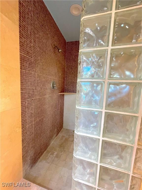 full bathroom featuring tile walls and walk in shower