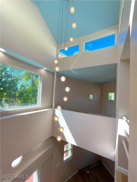 staircase featuring high vaulted ceiling