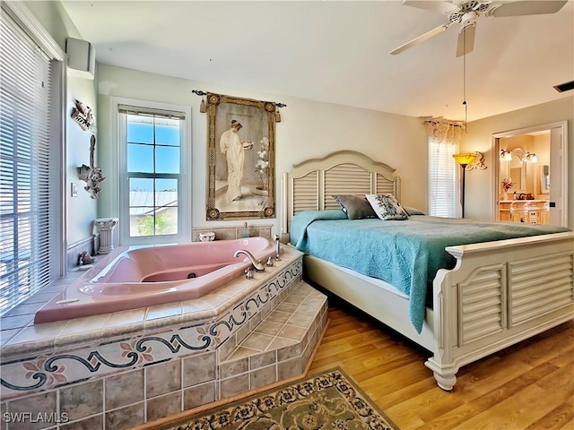 bedroom with visible vents, ceiling fan, and wood finished floors