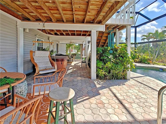 view of patio with an outdoor pool, a lanai, and a hot tub