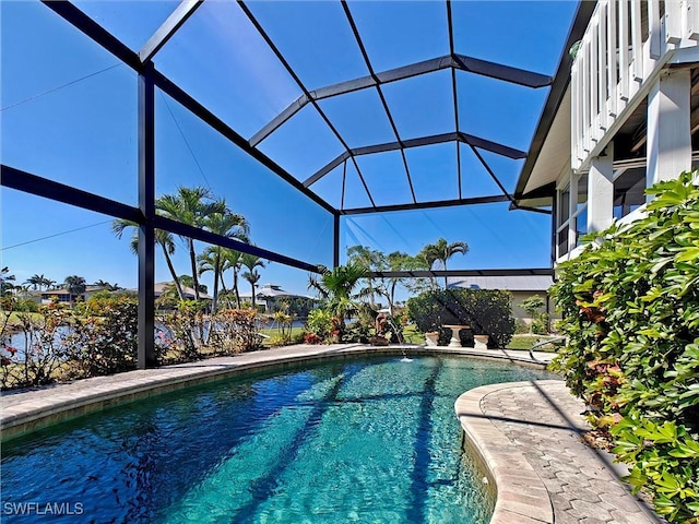 outdoor pool with glass enclosure and a patio