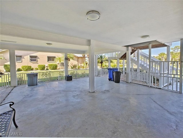 view of patio with stairway and fence